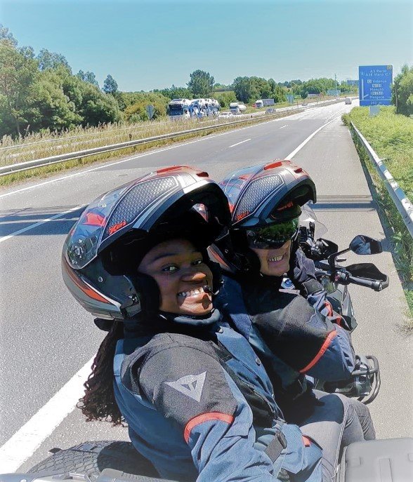 A couple on a motorcycle travelling and crossing the border