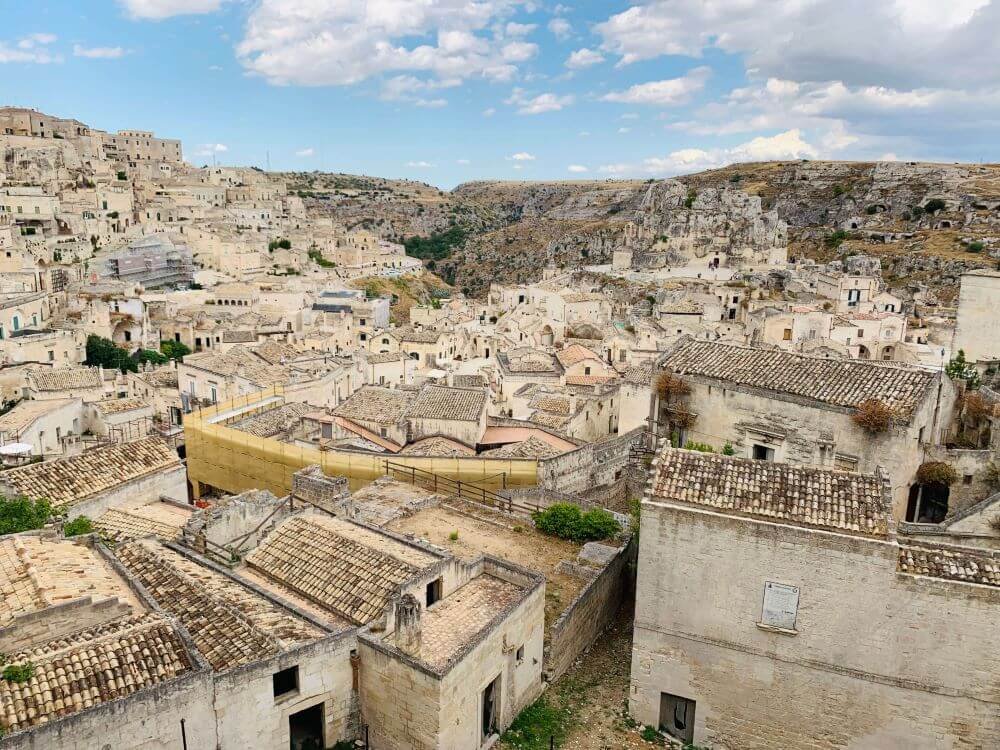 A landscape of a town made from cave houses with a valley dividing the town